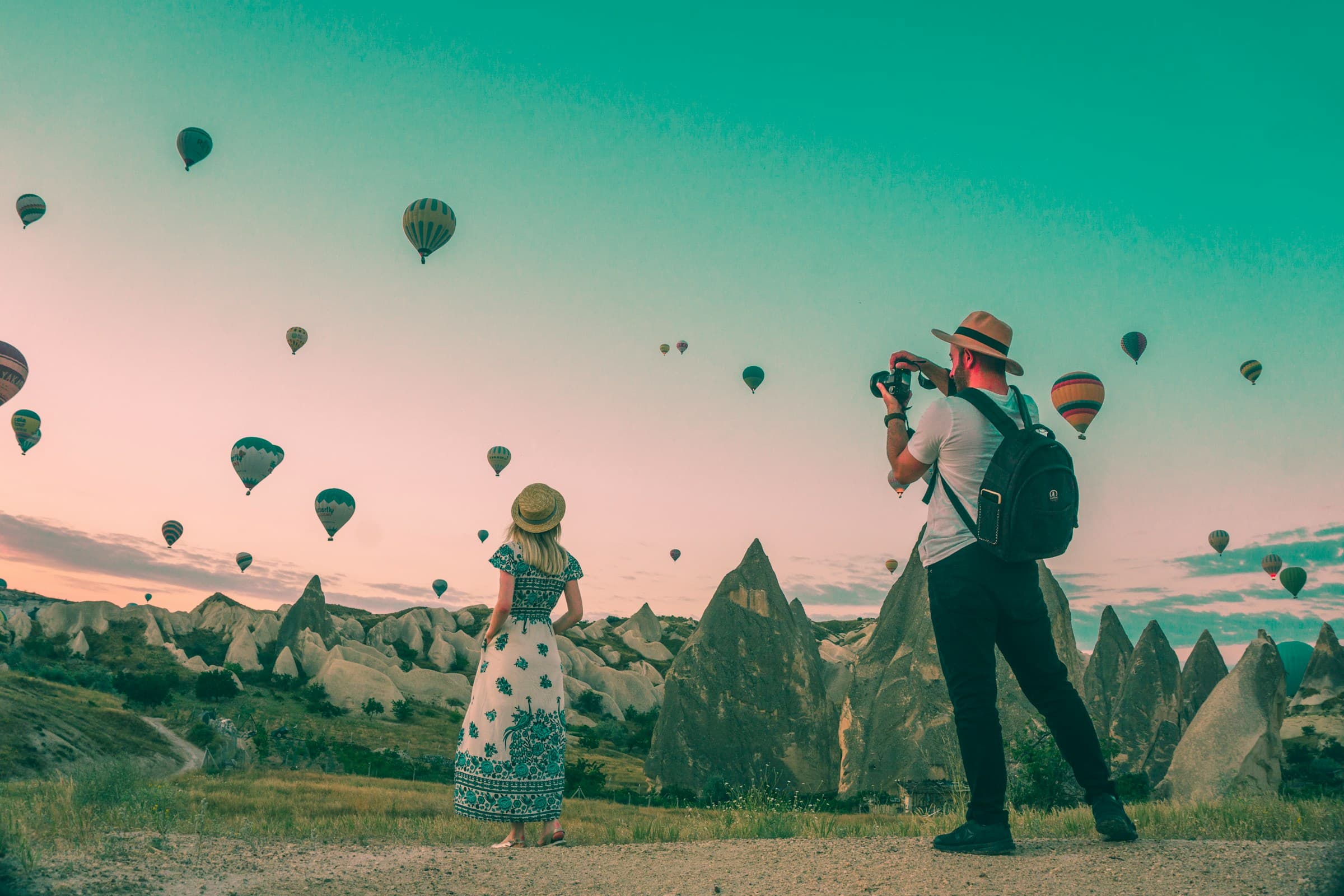 Hot air balloons over landscape